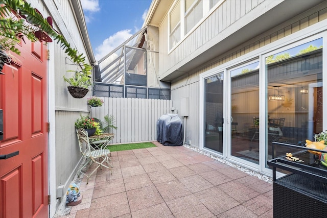 view of patio featuring grilling area and a lanai