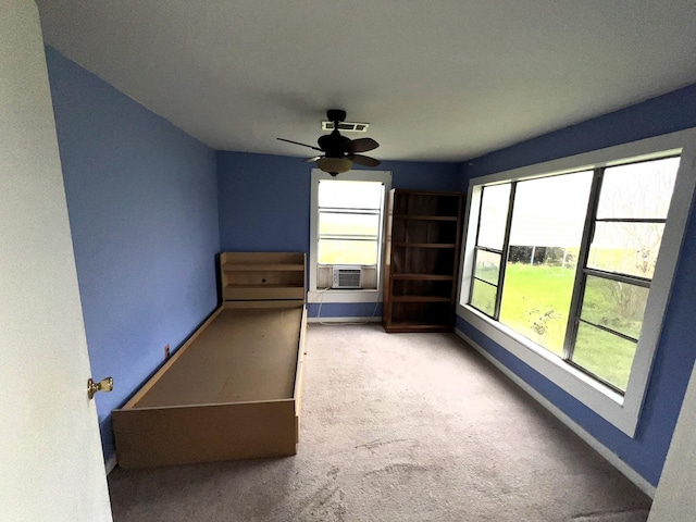 unfurnished bedroom with visible vents, baseboards, a ceiling fan, carpet, and cooling unit