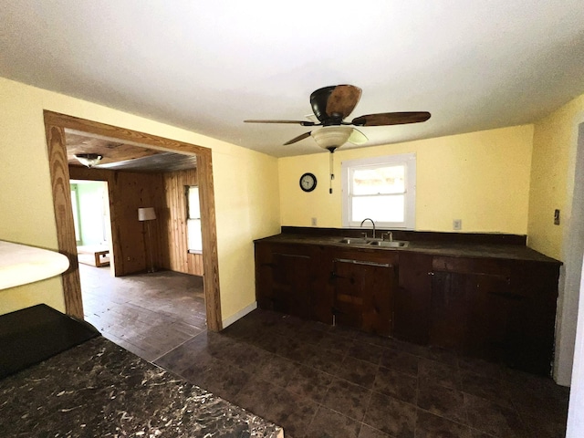 38440 Fisk Ln, Pattison, TX 77423 - kitchen with dark countertops, dark brown cabinetry, a ceiling fan, and plenty of natural light