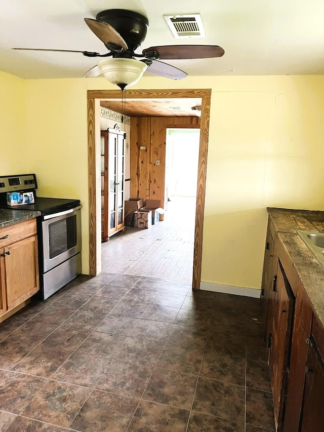 38440 Fisk Ln, Pattison, TX 77423 - kitchen with stainless steel electric stove, dark countertops, and ceiling fan