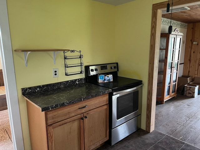 38440 Fisk Ln, Pattison, TX 77423 - kitchen featuring stainless steel range with electric cooktop, dark stone countertops, and brown cabinets