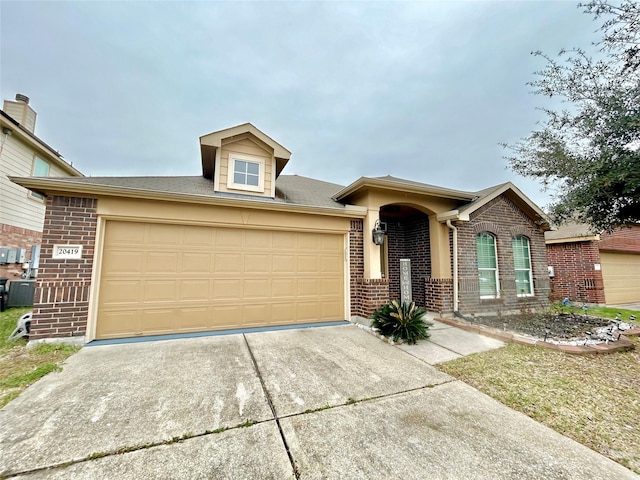 ranch-style house featuring a garage, driveway, and brick siding