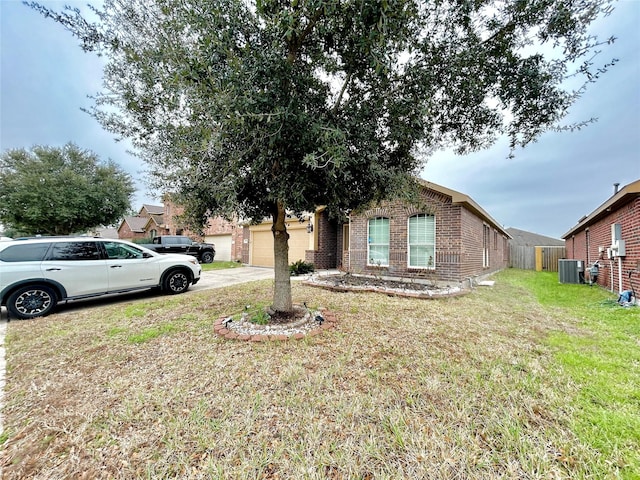 view of front of property featuring an attached garage, central AC, brick siding, driveway, and a front lawn