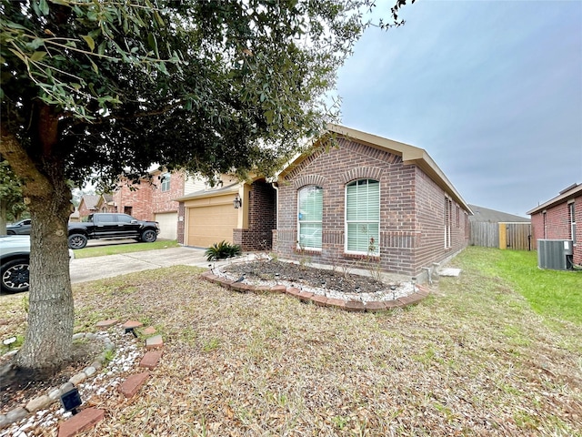 single story home with a front yard, concrete driveway, brick siding, and central AC unit