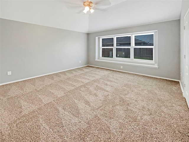 empty room with lofted ceiling, carpet, and baseboards