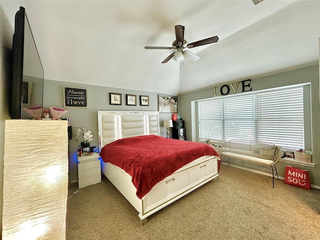 carpeted bedroom with a ceiling fan, vaulted ceiling, and a textured ceiling