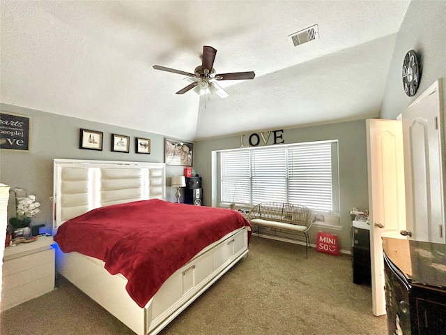 carpeted bedroom with lofted ceiling, visible vents, ceiling fan, and a textured ceiling