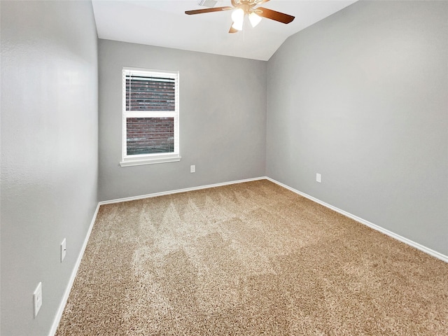 unfurnished room with lofted ceiling, carpet flooring, ceiling fan, and baseboards