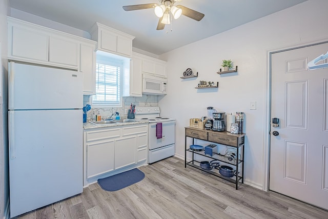 kitchen featuring light wood-type flooring, white appliances, white cabinets, and a sink