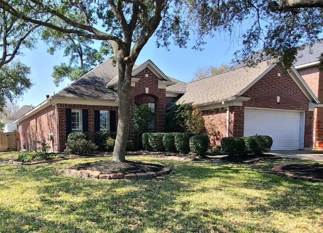 view of front of property with a front yard, an attached garage, brick siding, and concrete driveway