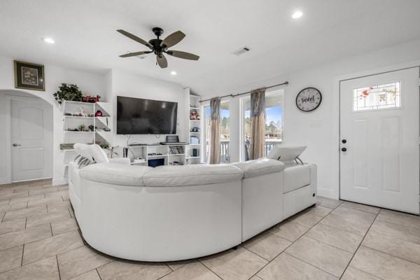 living room with ceiling fan, a wealth of natural light, and recessed lighting