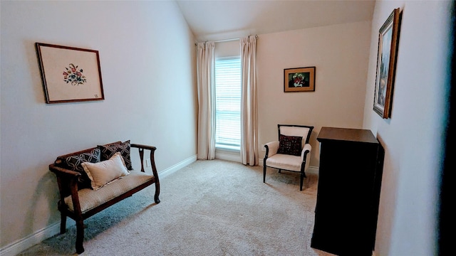 sitting room with vaulted ceiling, baseboards, and carpet floors