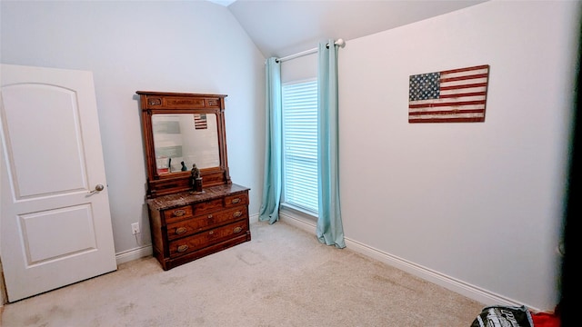 bedroom with baseboards, carpet, and lofted ceiling