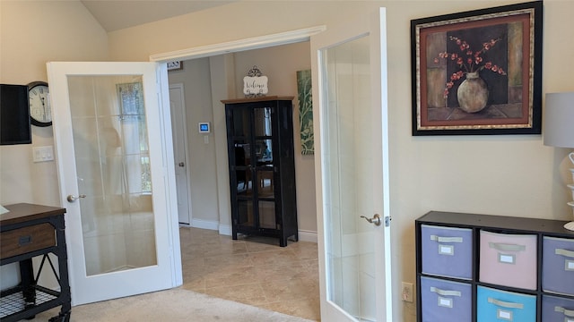 interior space with tile patterned floors, french doors, and baseboards