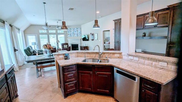 kitchen with a sink, decorative light fixtures, dishwasher, and a fireplace