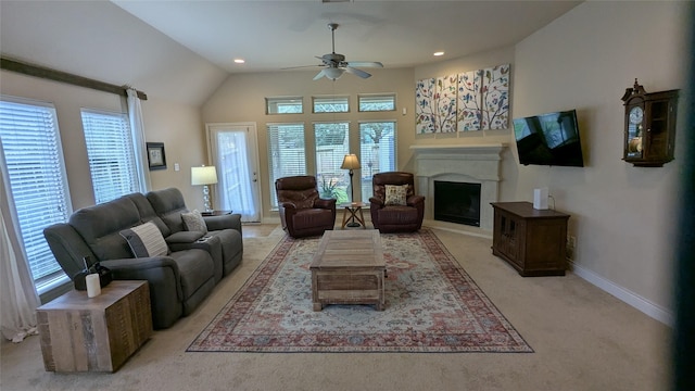 living area with plenty of natural light, a fireplace, a ceiling fan, and baseboards