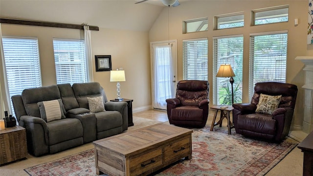 living area featuring a fireplace, vaulted ceiling, plenty of natural light, and a ceiling fan