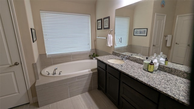 full bath with a garden tub and vanity