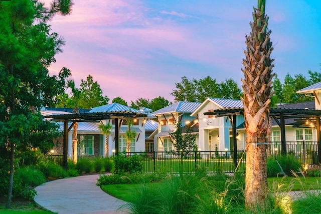 view of property's community featuring a pergola and fence