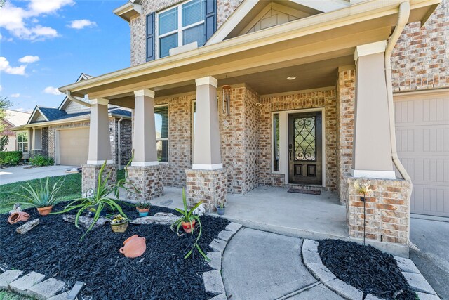 24111 Auburn Woods Ct, Porter, TX 77365 - entrance to property featuring covered porch, an attached garage, and brick siding