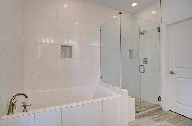 full bath featuring a shower stall and a bath