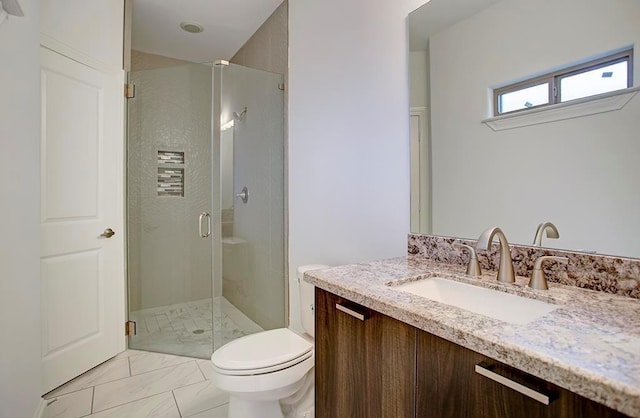 bathroom with toilet, a stall shower, marble finish floor, and vanity