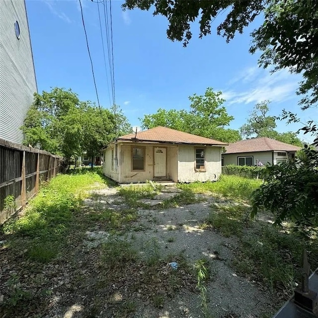 back of house with fence