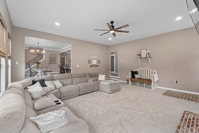 carpeted living area with stairs, recessed lighting, ceiling fan with notable chandelier, and baseboards