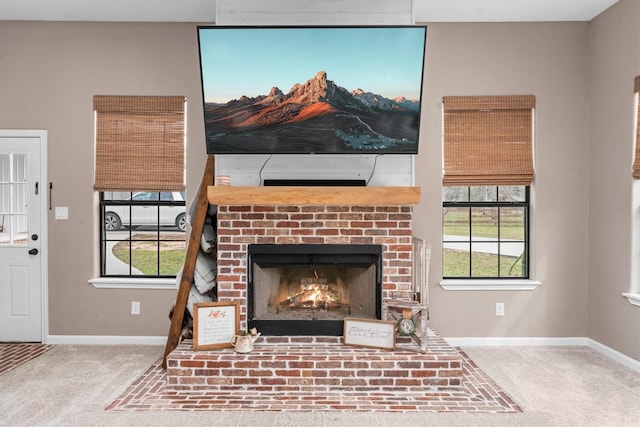 interior details featuring carpet floors, a fireplace, and baseboards