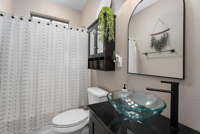 bathroom with vanity, toilet, and a shower with curtain