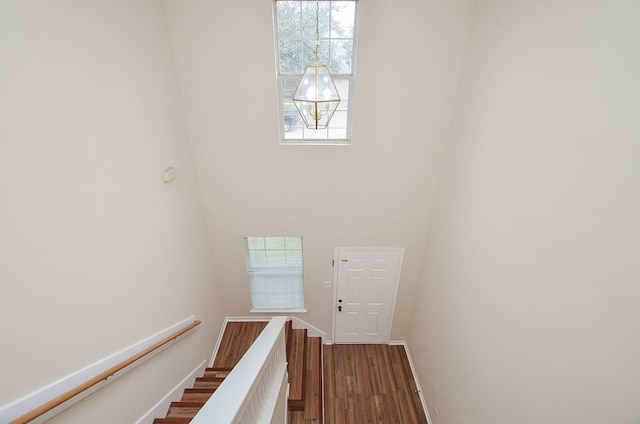 stairs with baseboards and wood finished floors