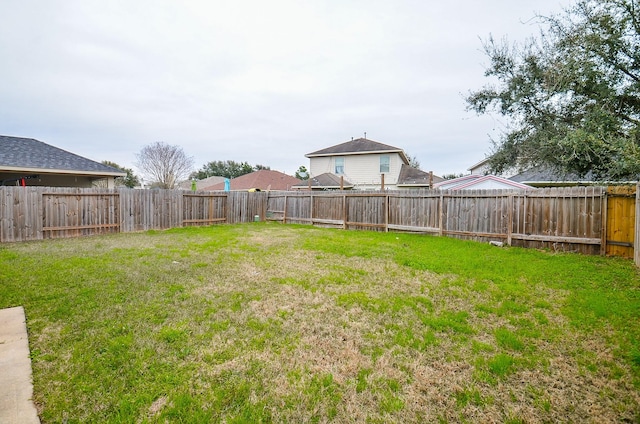 view of yard with a fenced backyard