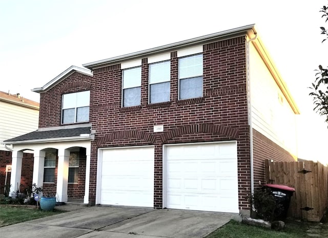 view of front of property featuring a garage, concrete driveway, brick siding, and fence