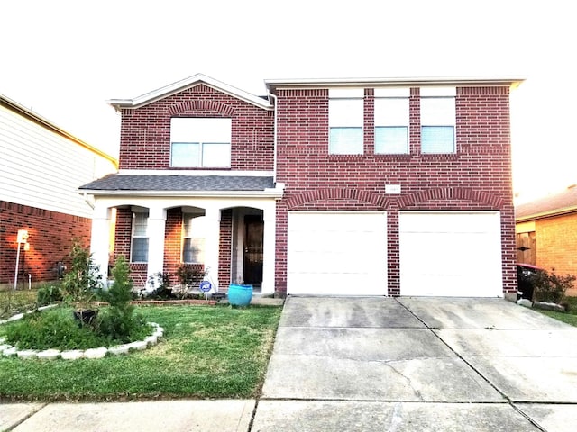 traditional home featuring a front yard, brick siding, driveway, and an attached garage