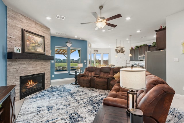 living area featuring a fireplace, visible vents, and recessed lighting