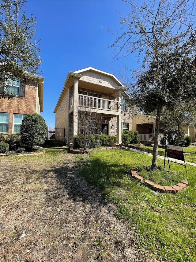 view of front of property with a balcony