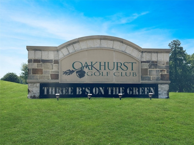 community / neighborhood sign with a lawn