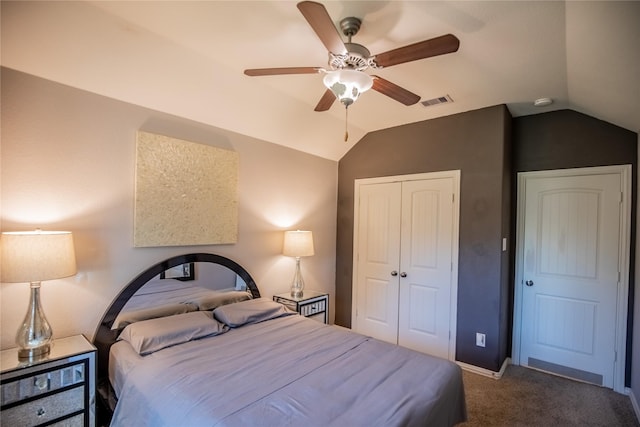 bedroom with visible vents, a closet, carpet, lofted ceiling, and ceiling fan