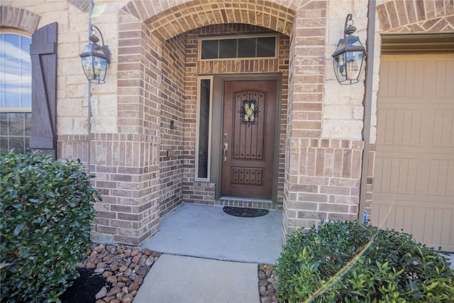 view of exterior entry with brick siding