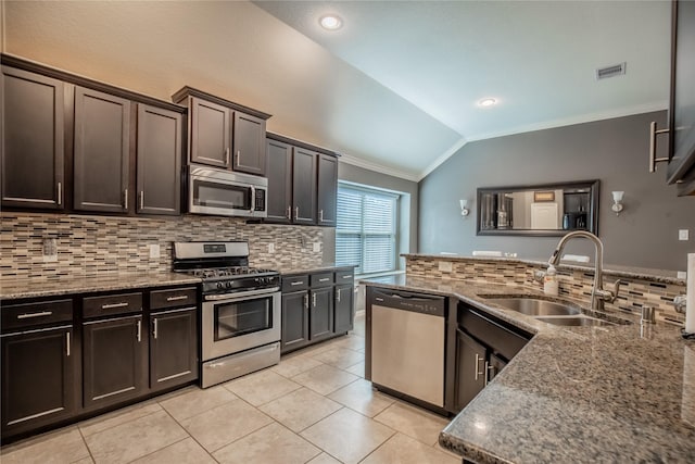 kitchen with visible vents, a sink, dark brown cabinetry, appliances with stainless steel finishes, and lofted ceiling