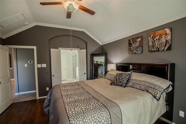 bedroom featuring lofted ceiling, wood finished floors, baseboards, and ceiling fan