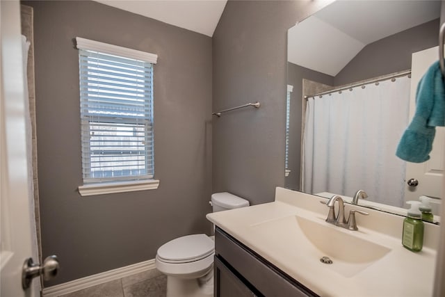 bathroom featuring baseboards, toilet, vaulted ceiling, tile patterned floors, and vanity