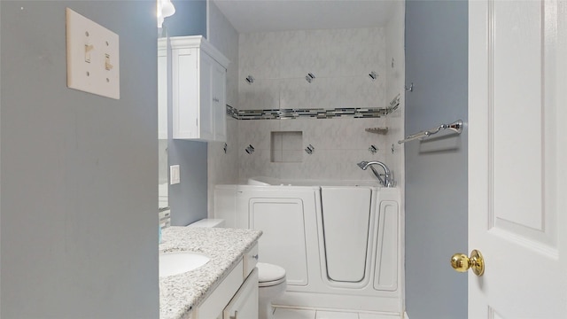 bathroom with vanity, walk in shower, a bathing tub, and toilet