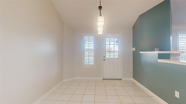 doorway featuring baseboards and tile patterned floors