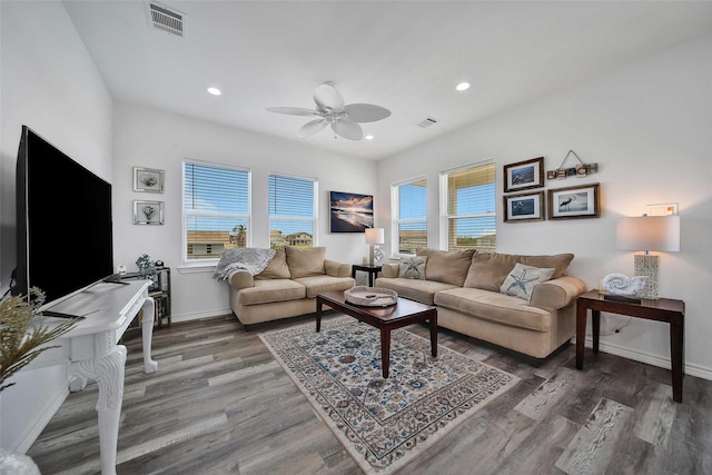 living area with plenty of natural light, wood finished floors, and visible vents