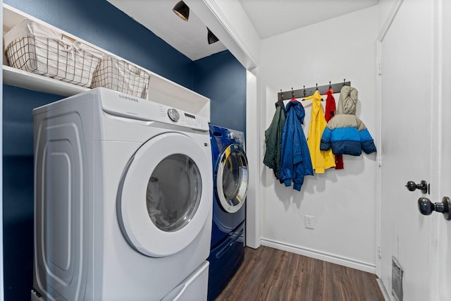 laundry area with laundry area, visible vents, baseboards, dark wood finished floors, and washing machine and dryer