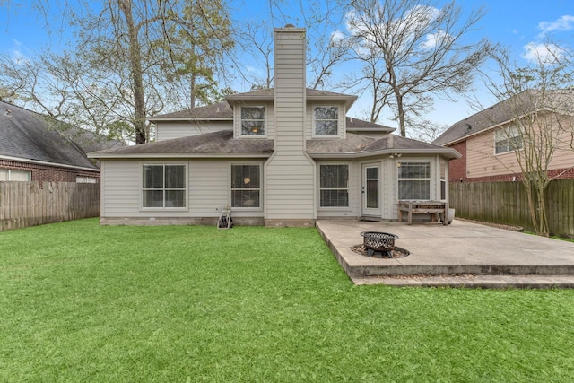 back of property featuring a patio area, a fenced backyard, a fire pit, and a lawn