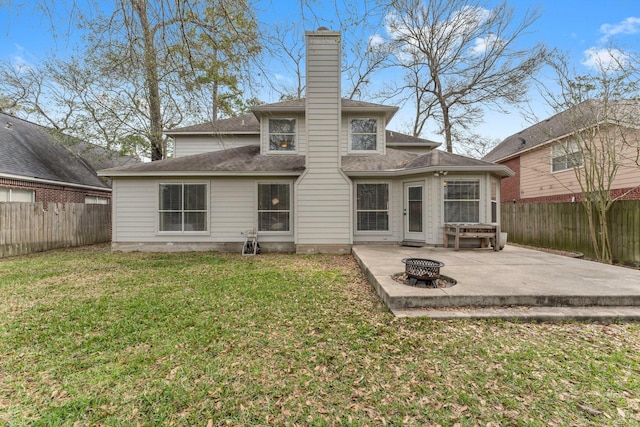 back of property with an outdoor fire pit, a fenced backyard, a lawn, and a patio