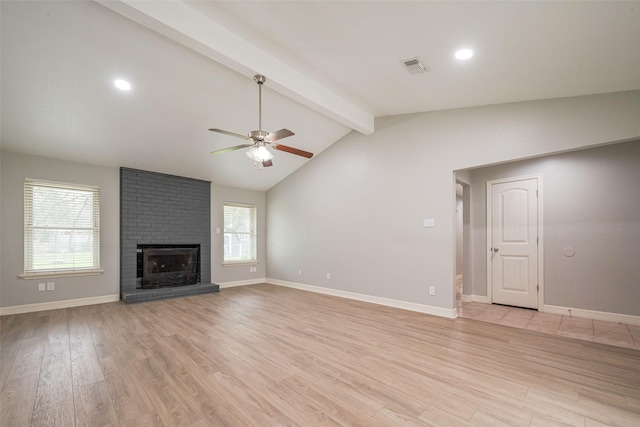 unfurnished living room featuring vaulted ceiling with beams, visible vents, baseboards, light wood-type flooring, and a brick fireplace