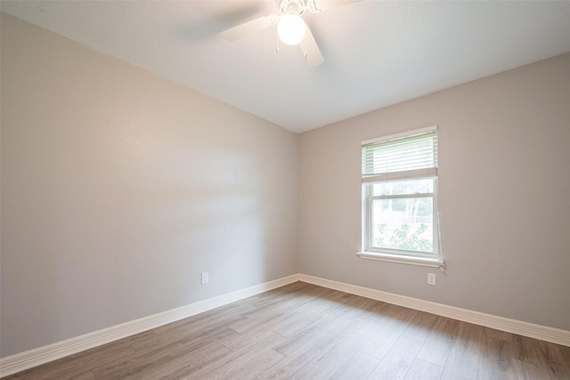 spare room featuring light wood-type flooring, ceiling fan, and baseboards